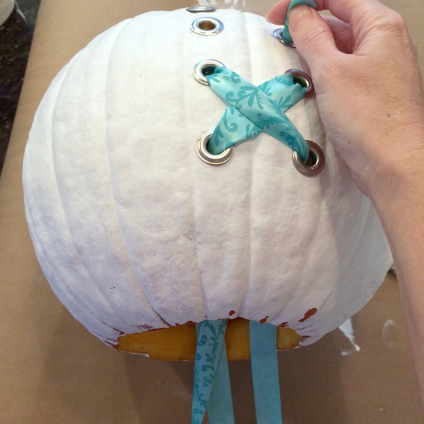 String ribbon through grommets to create a corset pumpkin