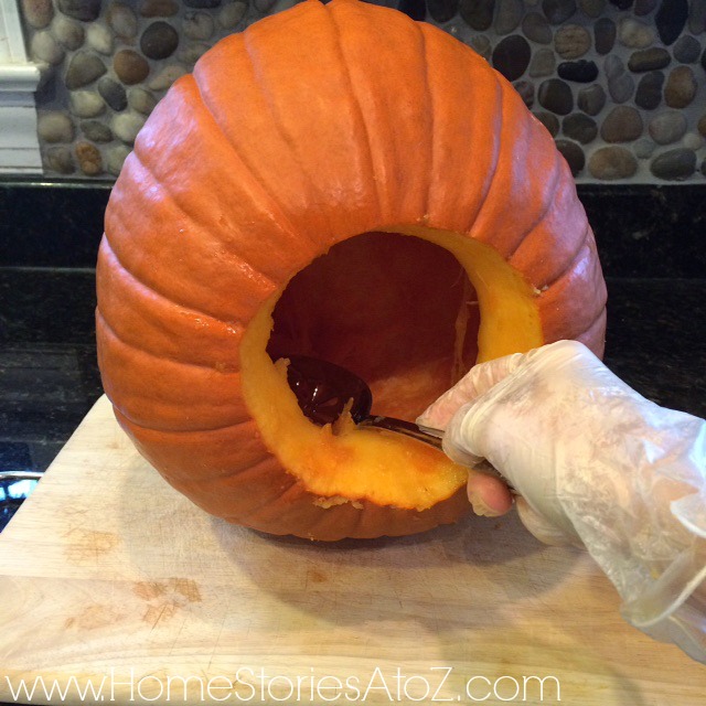 Use large spoon to scoop out pumpkin inards