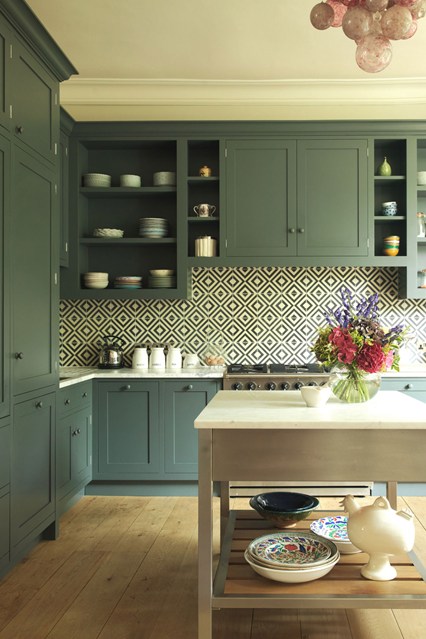 green kitchen cabinets patterned backsplash