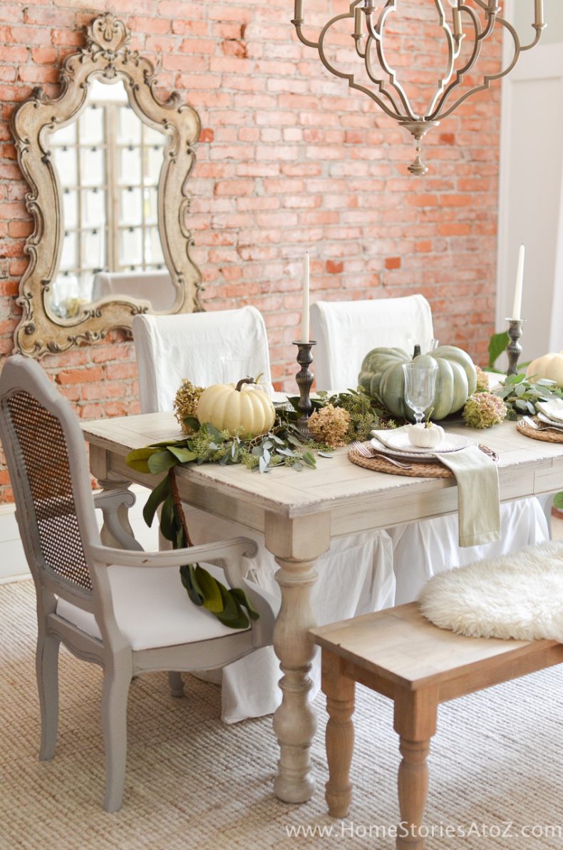 Beautiful fall table decorations! Love the brick wall. 