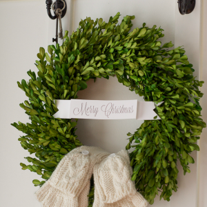 Place mittens on boxwood wreath for a fun decoration