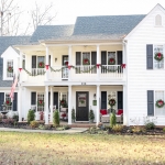 classic red and green christmas exterior white house black shutters