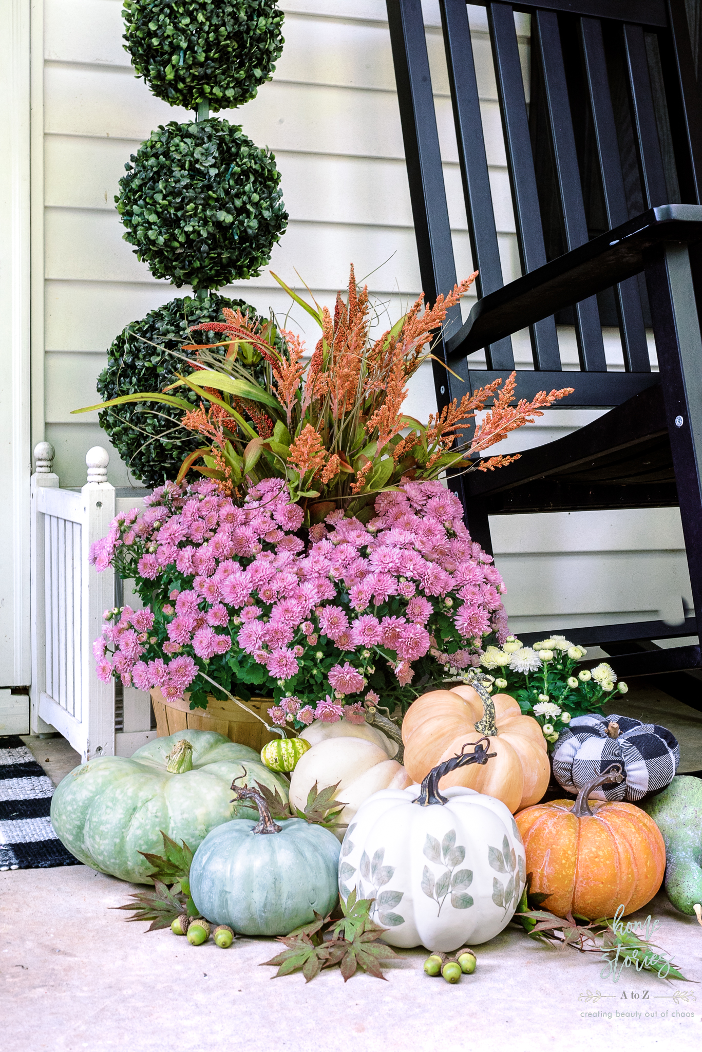 faux pumpkins mixed with real pumpkins on fall porch